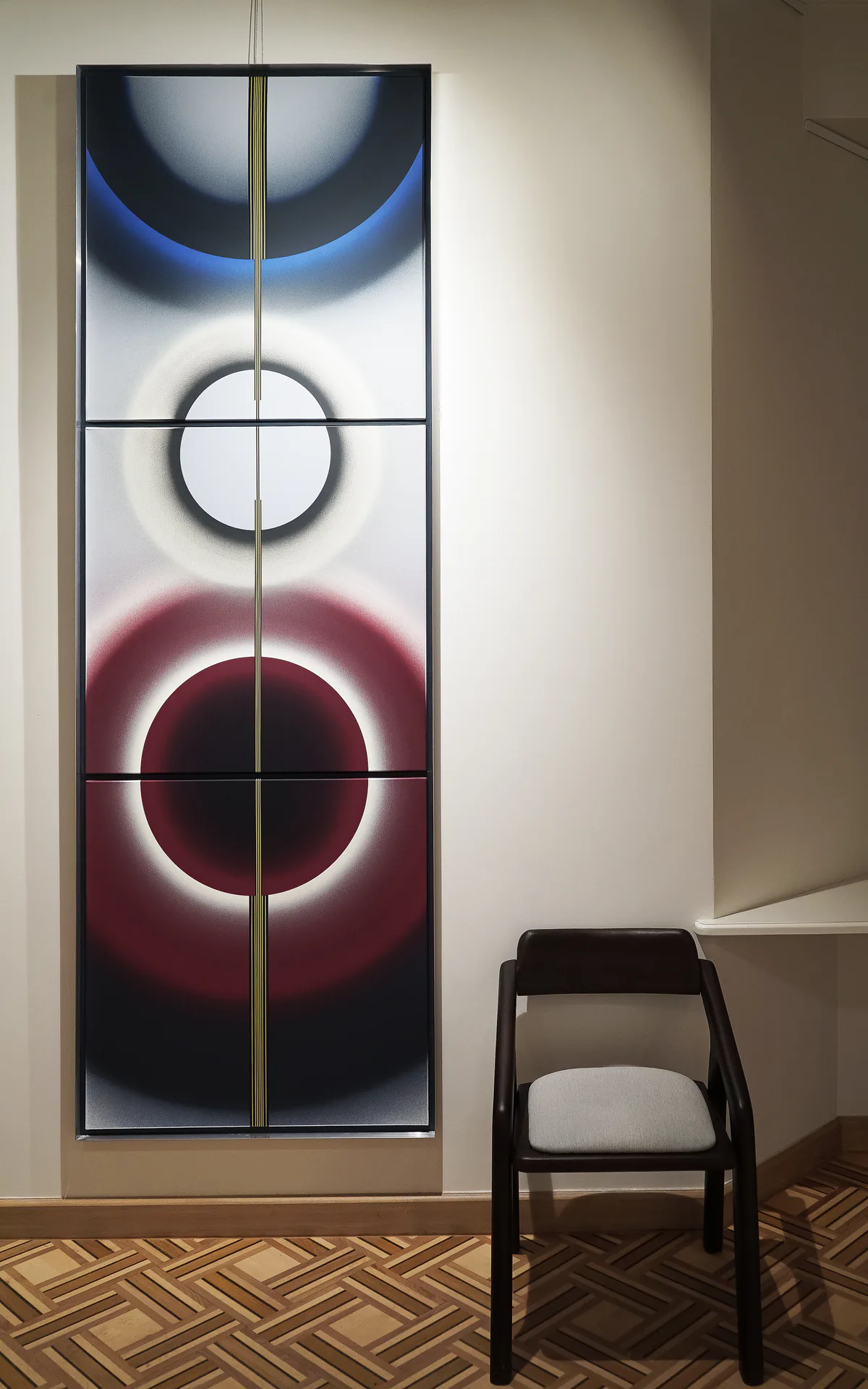 Pi Square exhibition view with artwork, chair, and gallery interior context