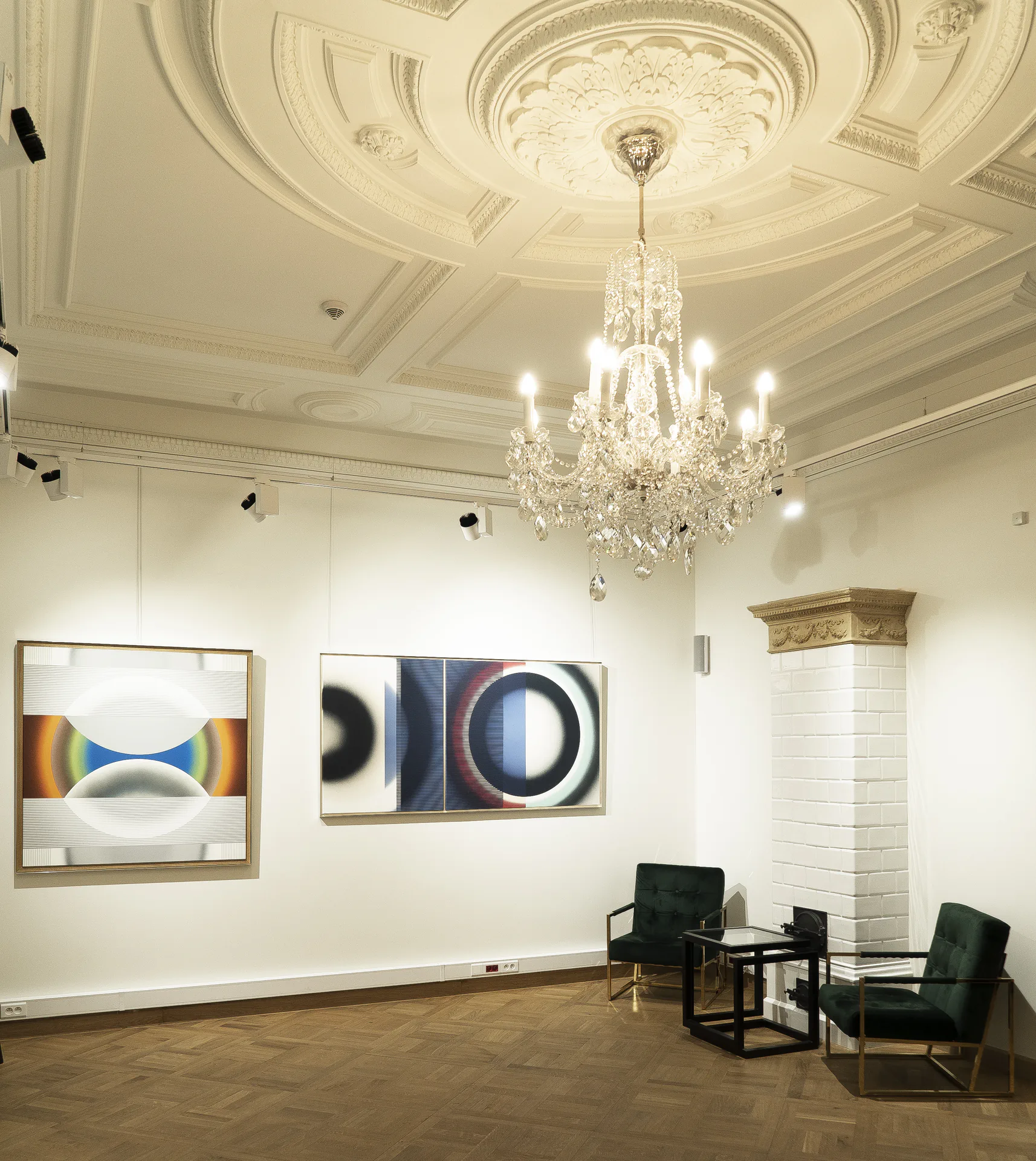 Pi Square exhibition interior with chandelier, paintings, and architectural light